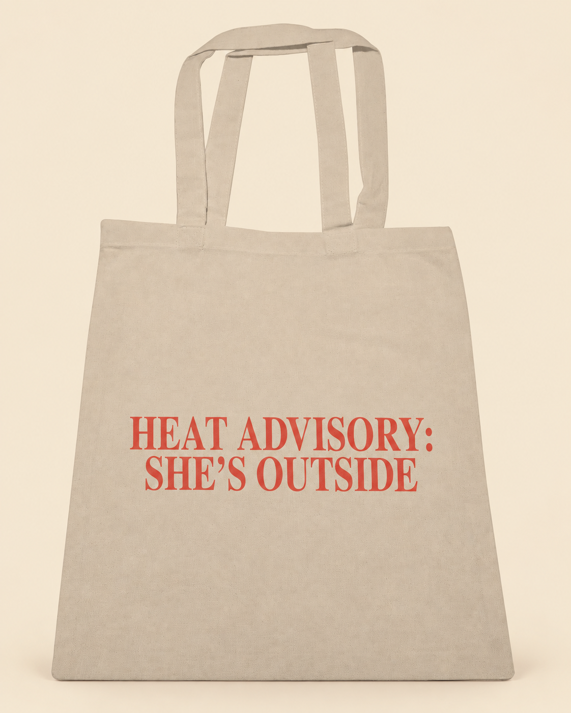 Heat Advisory She's Outside canvas tote on a cream background