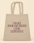 I Make Poor Decisions Look Expensive canvas tote on a cream background