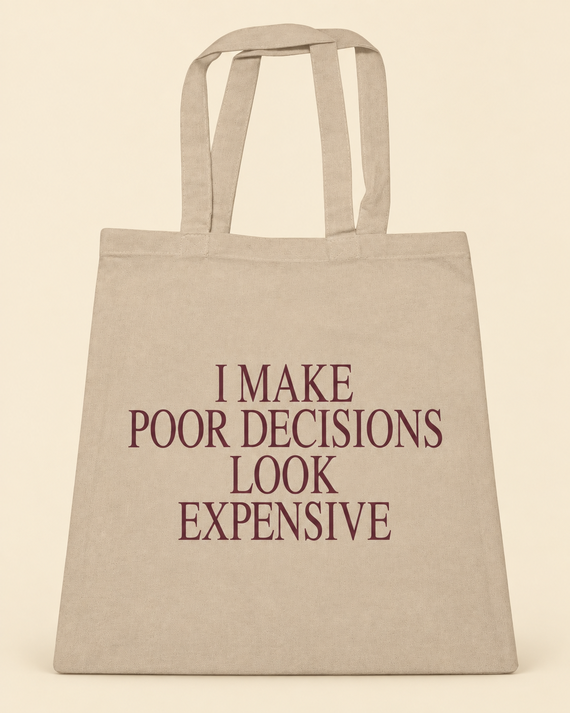 I Make Poor Decisions Look Expensive canvas tote on a cream background